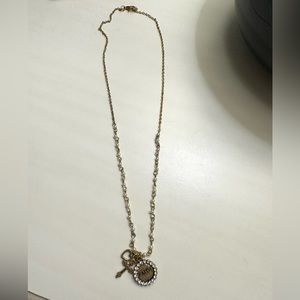 Gold and pearl necklace with “Faith” and heart charm.